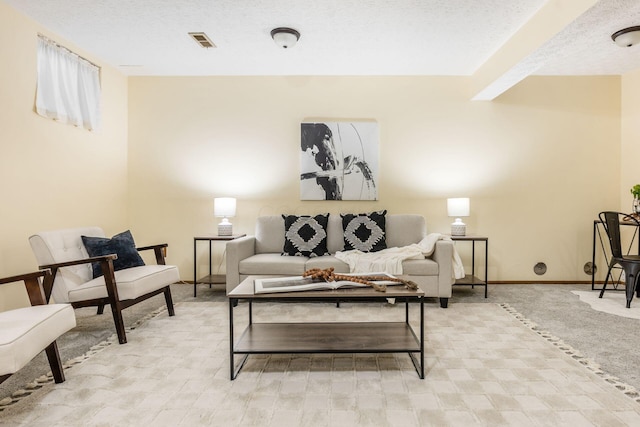 carpeted living room featuring a textured ceiling