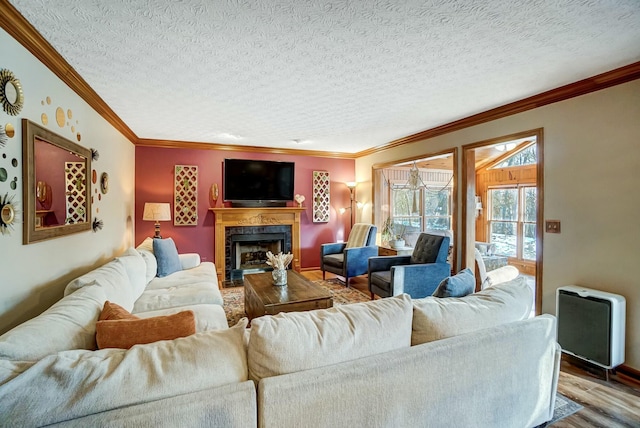 living room with crown molding, a textured ceiling, and light wood-type flooring