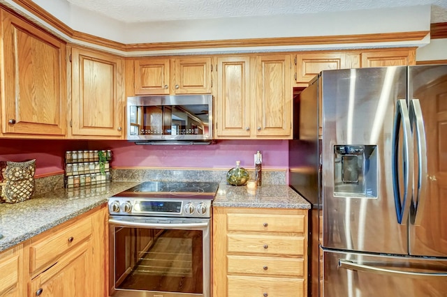 kitchen with light stone countertops and appliances with stainless steel finishes