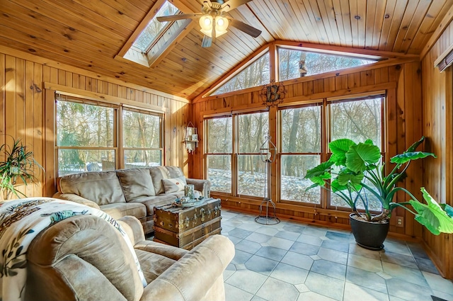 living room with plenty of natural light, vaulted ceiling with skylight, and wood ceiling