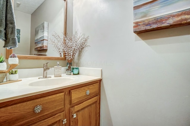 bathroom featuring vanity and a textured ceiling