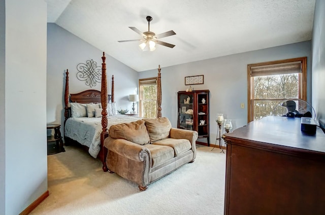 carpeted bedroom featuring vaulted ceiling and ceiling fan