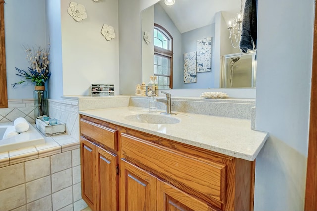 bathroom with lofted ceiling, vanity, shower with separate bathtub, and tile patterned floors