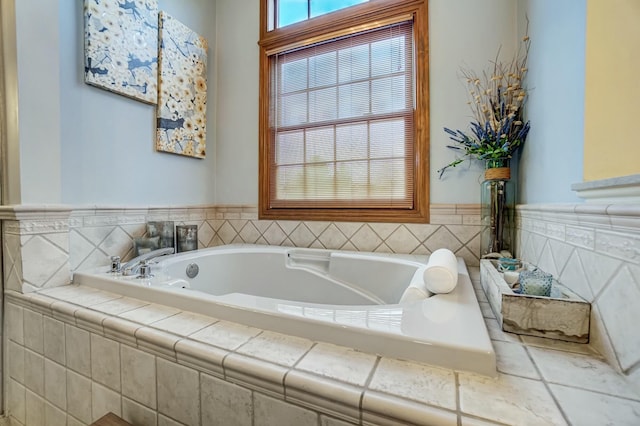 bathroom with a relaxing tiled tub and a wealth of natural light