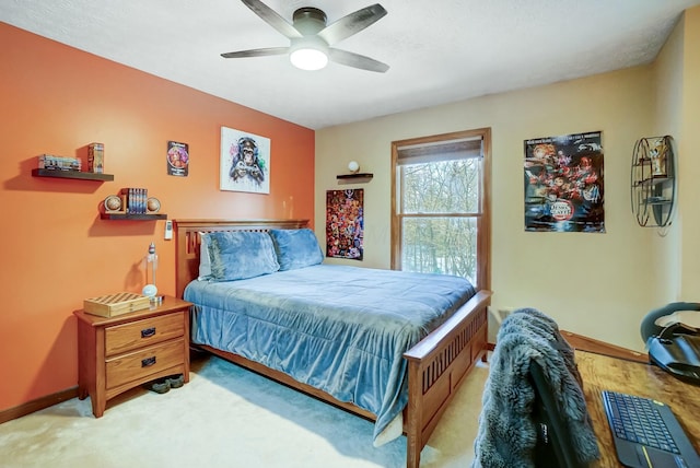 bedroom featuring light colored carpet and ceiling fan