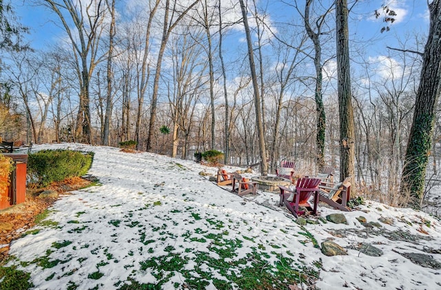 snowy yard featuring an outdoor fire pit