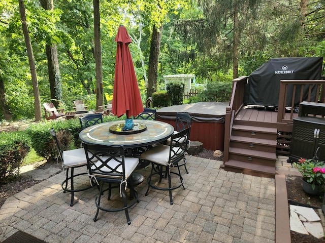 view of patio / terrace with area for grilling, a hot tub, and a deck