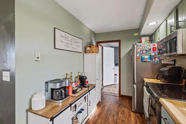 kitchen featuring green cabinetry, dark hardwood / wood-style floors, electric range oven, and white cabinets