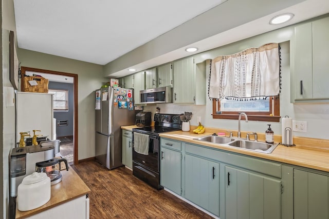 kitchen with sink, dark wood-type flooring, and appliances with stainless steel finishes