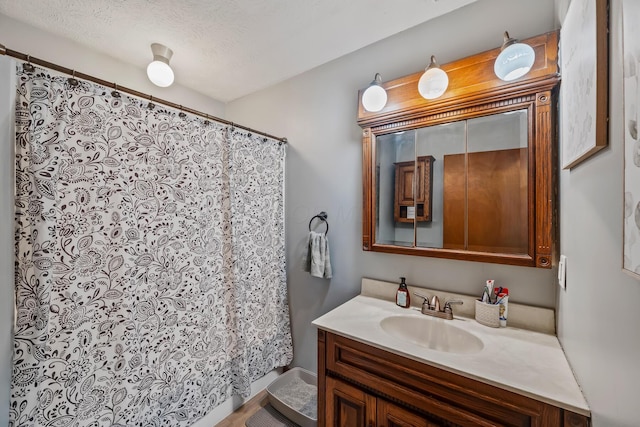 bathroom featuring vanity and a textured ceiling