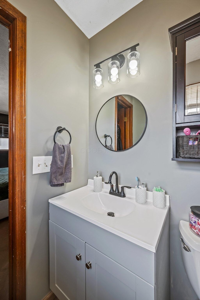 bathroom with vanity and toilet