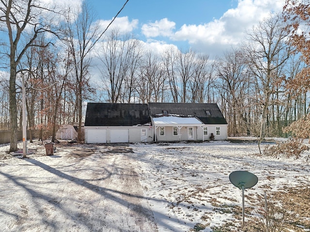 view of snow covered back of property