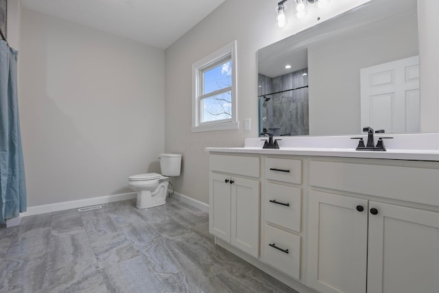 bathroom featuring vanity, toilet, and a shower with shower curtain