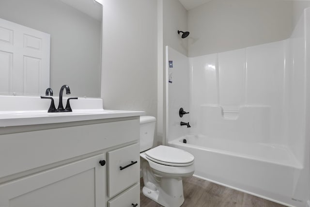 full bathroom with vanity, shower / washtub combination, hardwood / wood-style floors, and toilet