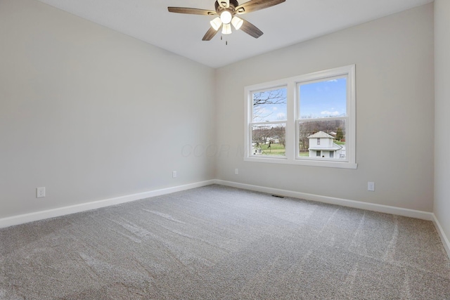 carpeted spare room featuring ceiling fan