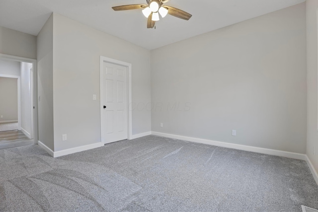 empty room featuring ceiling fan and carpet flooring