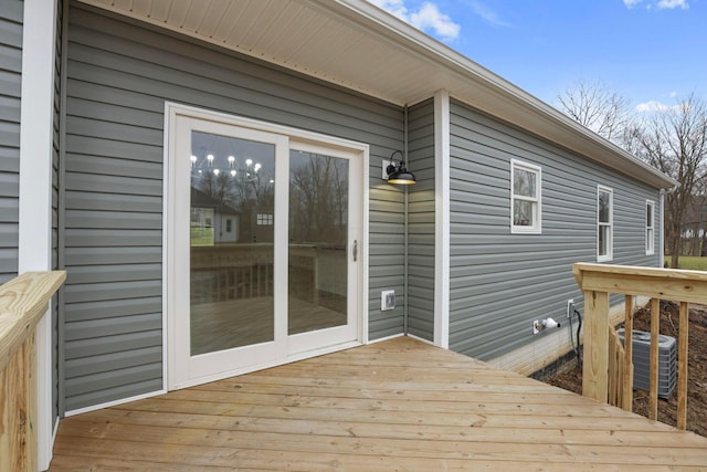 wooden deck featuring central AC unit