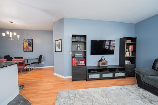 living room featuring hardwood / wood-style flooring and a notable chandelier