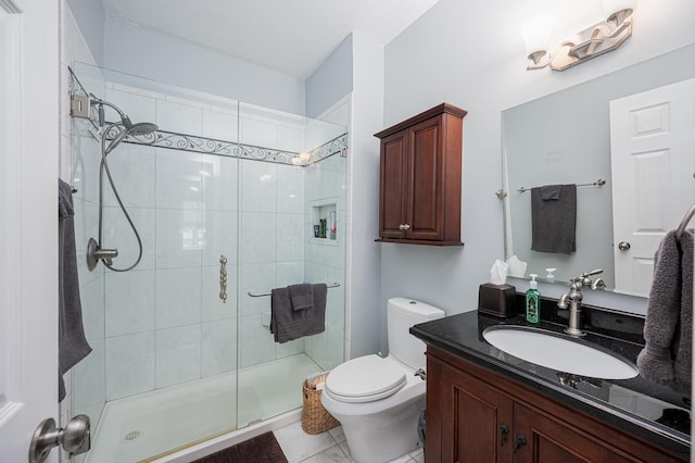 bathroom featuring vanity, tile patterned floors, toilet, and walk in shower