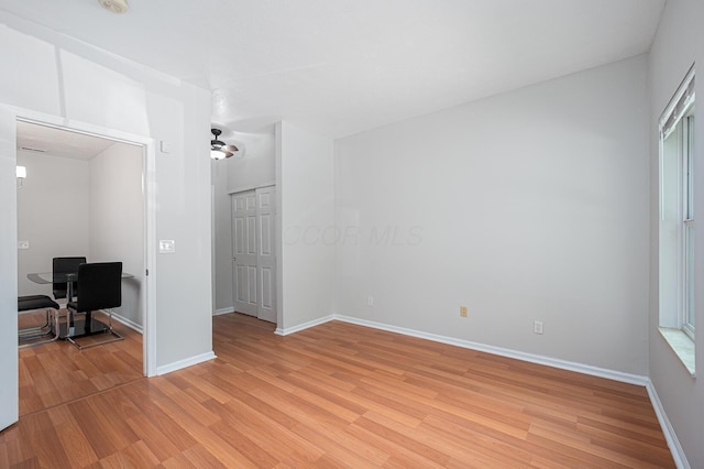 674 Park St, Columbus, OH 43215 - spare room with light wood-style flooring, baseboards, a desk, and a ceiling fan