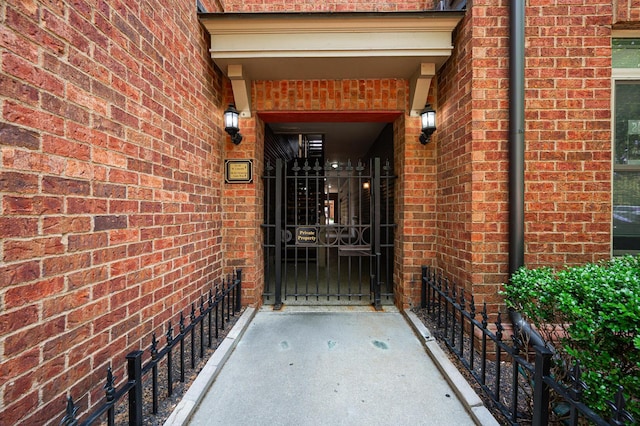 674 Park St, Columbus, OH 43215 - doorway to property featuring brick siding and a gate