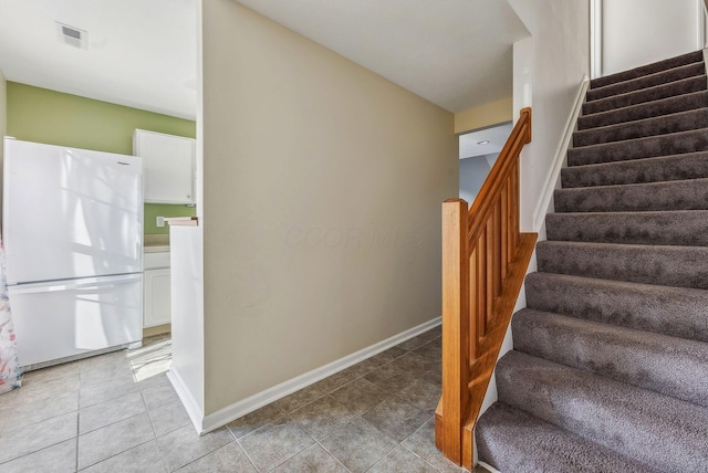 stairway featuring tile patterned floors