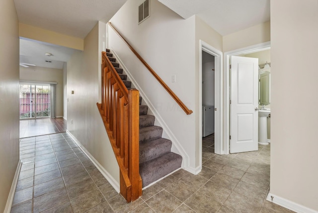 stairs featuring tile patterned flooring