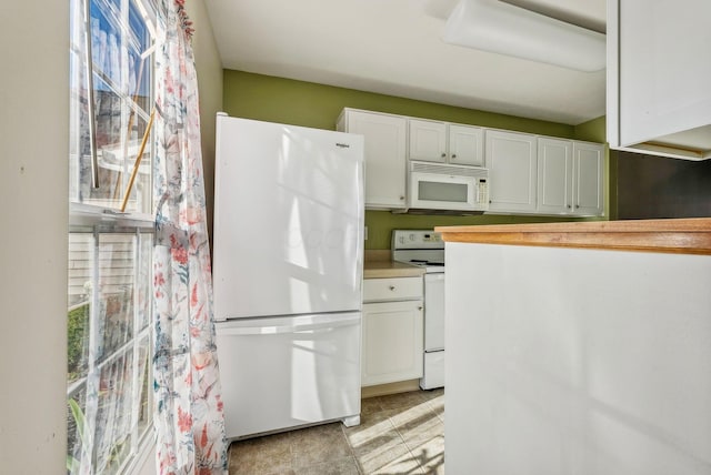 kitchen with white cabinets and white appliances