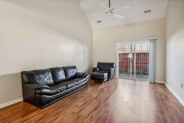 living room featuring ceiling fan, wood-type flooring, and high vaulted ceiling