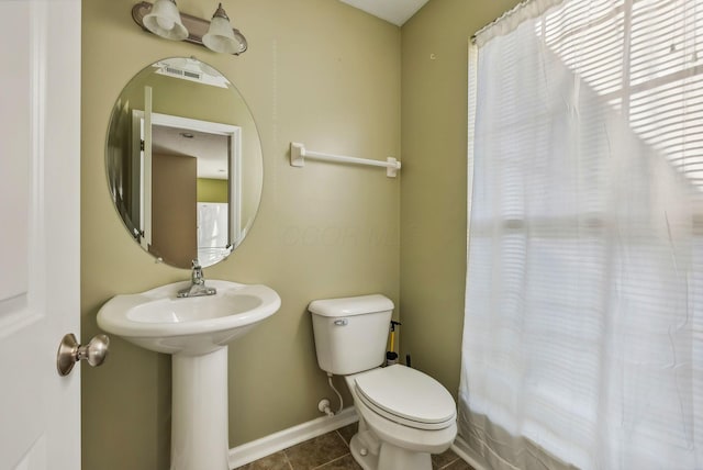 bathroom with tile patterned floors, toilet, and shower / bath combo