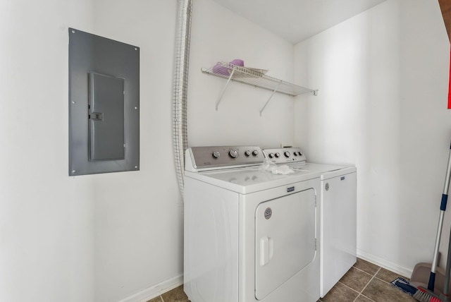 laundry room with separate washer and dryer, electric panel, and dark tile patterned floors