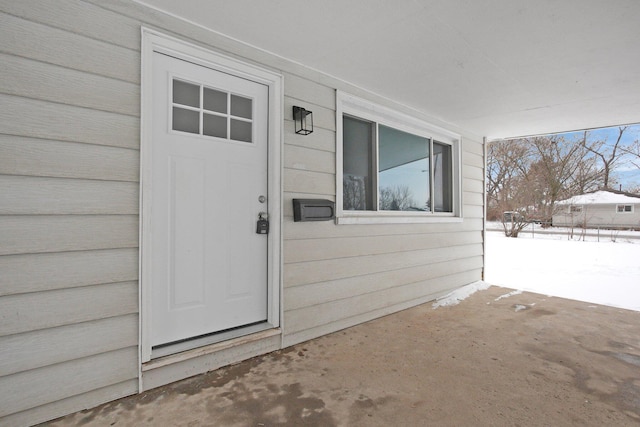 view of snow covered property entrance