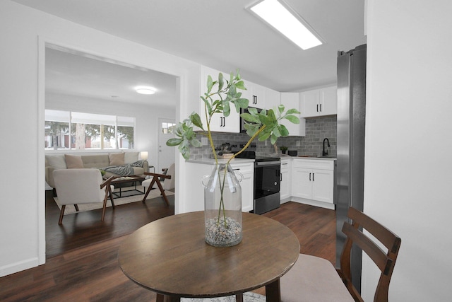 dining room featuring dark wood-type flooring and sink