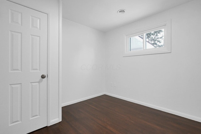 spare room featuring dark hardwood / wood-style floors