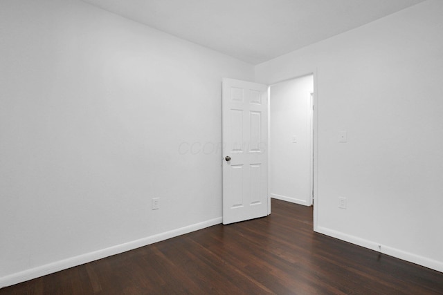 unfurnished room with dark hardwood / wood-style floors