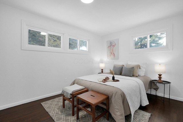 bedroom with dark wood-type flooring