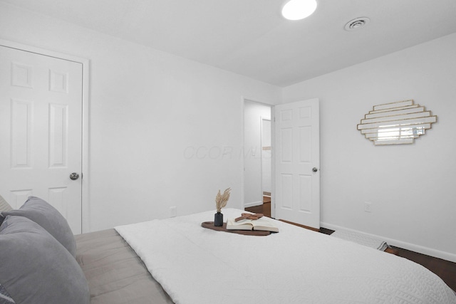 bedroom with dark wood-type flooring