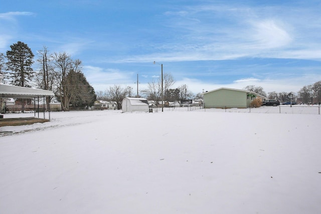 snowy yard with a shed