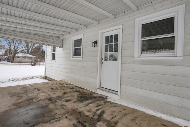 view of snow covered property entrance