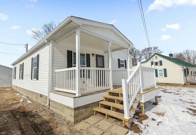 view of front of home with covered porch and crawl space