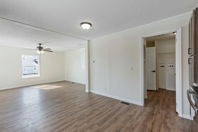 empty room with baseboards and dark wood finished floors