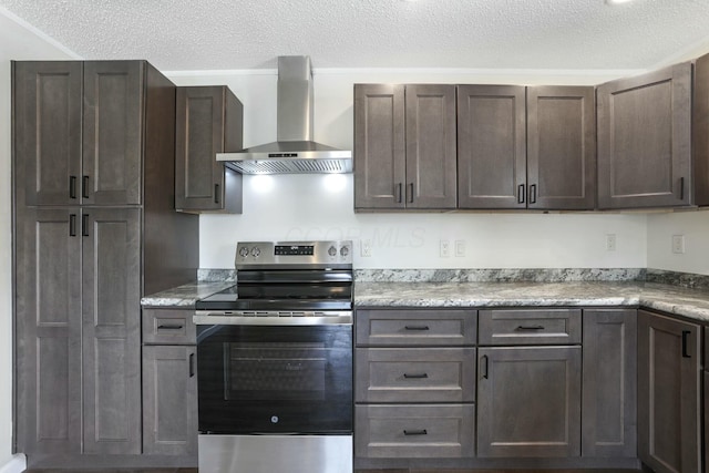 kitchen featuring stainless steel range with electric cooktop, dark brown cabinetry, wall chimney range hood, and a textured ceiling