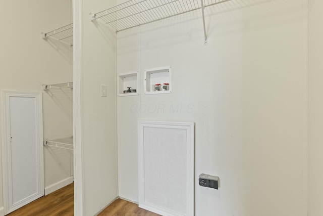 clothes washing area featuring hookup for a washing machine, laundry area, and wood finished floors