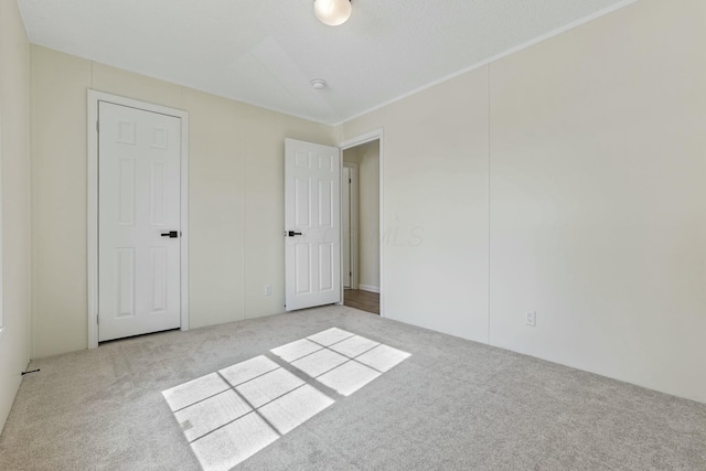 unfurnished bedroom featuring light carpet