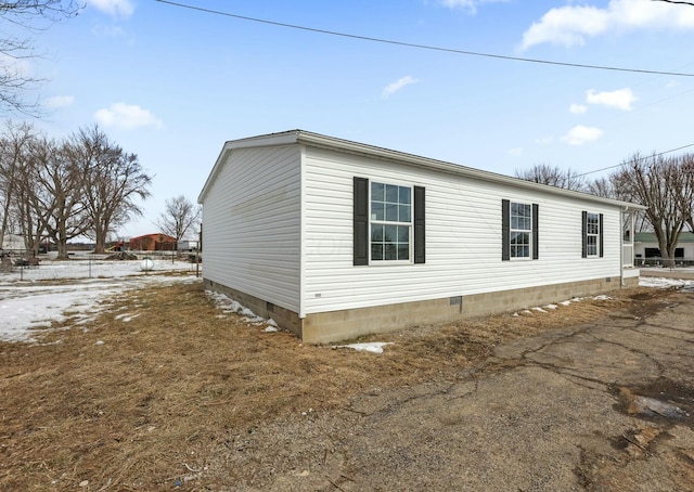 view of side of home featuring crawl space