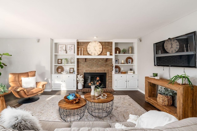 living room with a fireplace and dark wood-type flooring