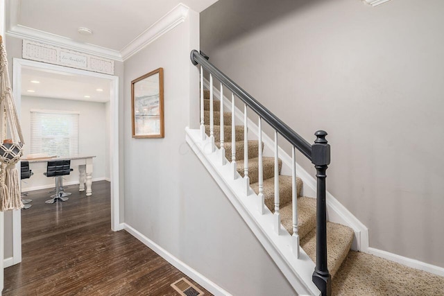 stairs with hardwood / wood-style floors and ornamental molding