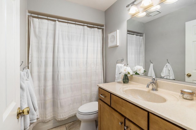 bathroom featuring vanity, tile patterned flooring, and toilet