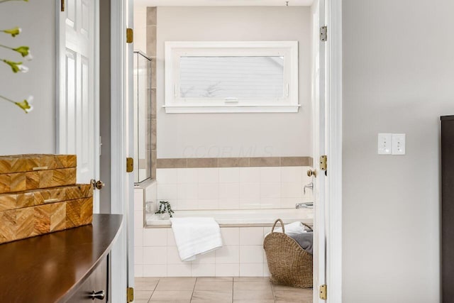 bathroom featuring tile patterned flooring and a tub