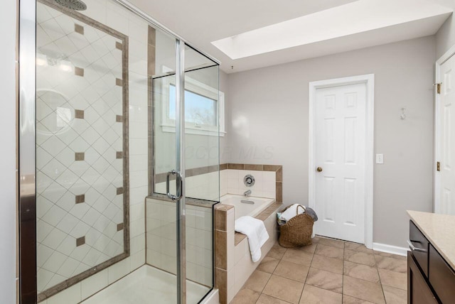 bathroom with vanity, separate shower and tub, tile patterned floors, and a skylight